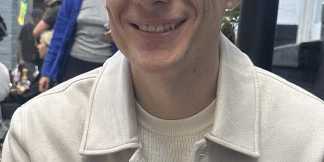 Hamish Hallett, Account Manager at Ranieri Agency, smiling outdoors.